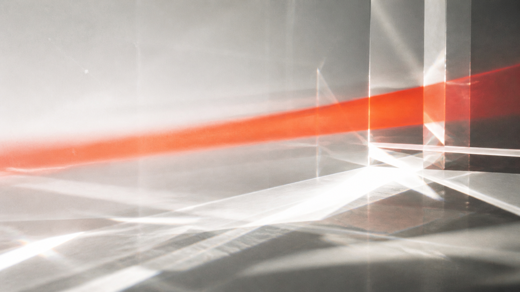 Vermilion projector light refracting through optical glass